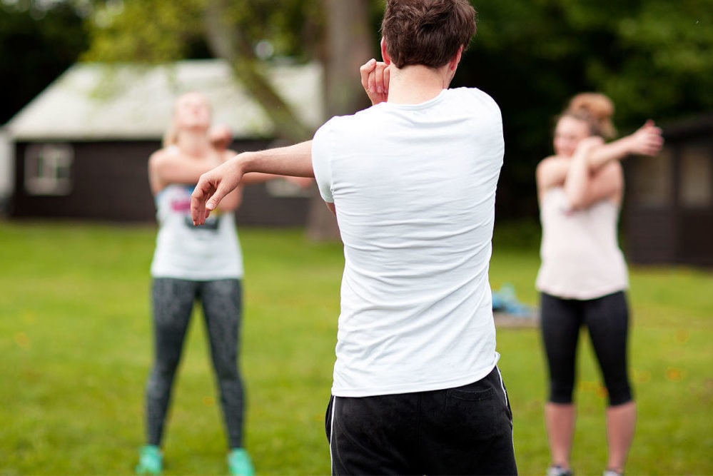 Students stretching before a fitness session outdoors